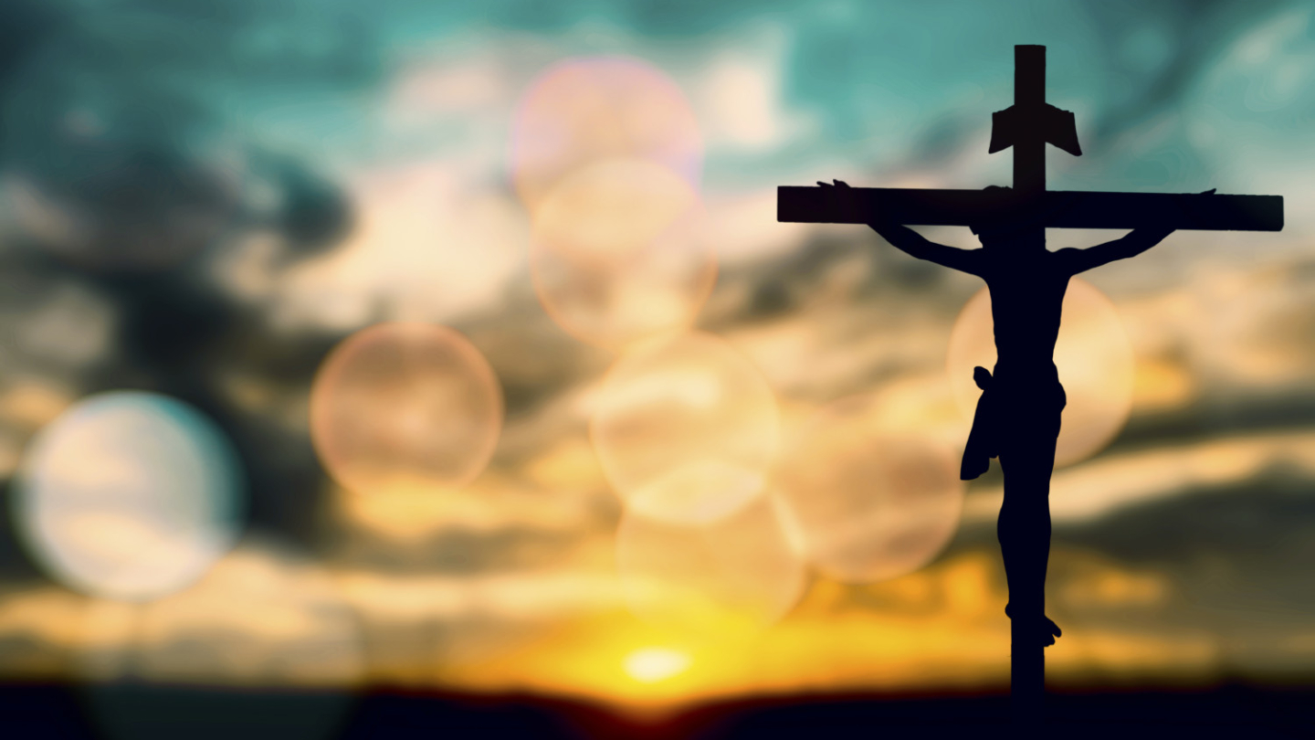 Silhouette of Jesus with Cross over sunset concept for religion, worship, prayer and praise.