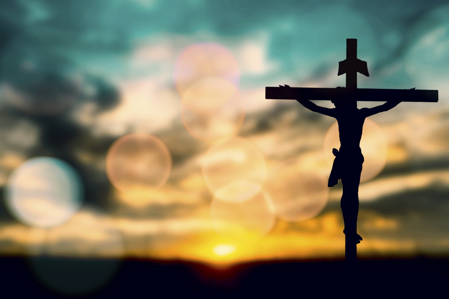 Silhouette of Jesus with Cross over sunset concept for religion, worship, prayer and praise.