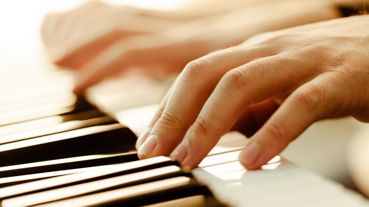 closeup-hands-playing-piano-music-hobby-concept_93675-131536